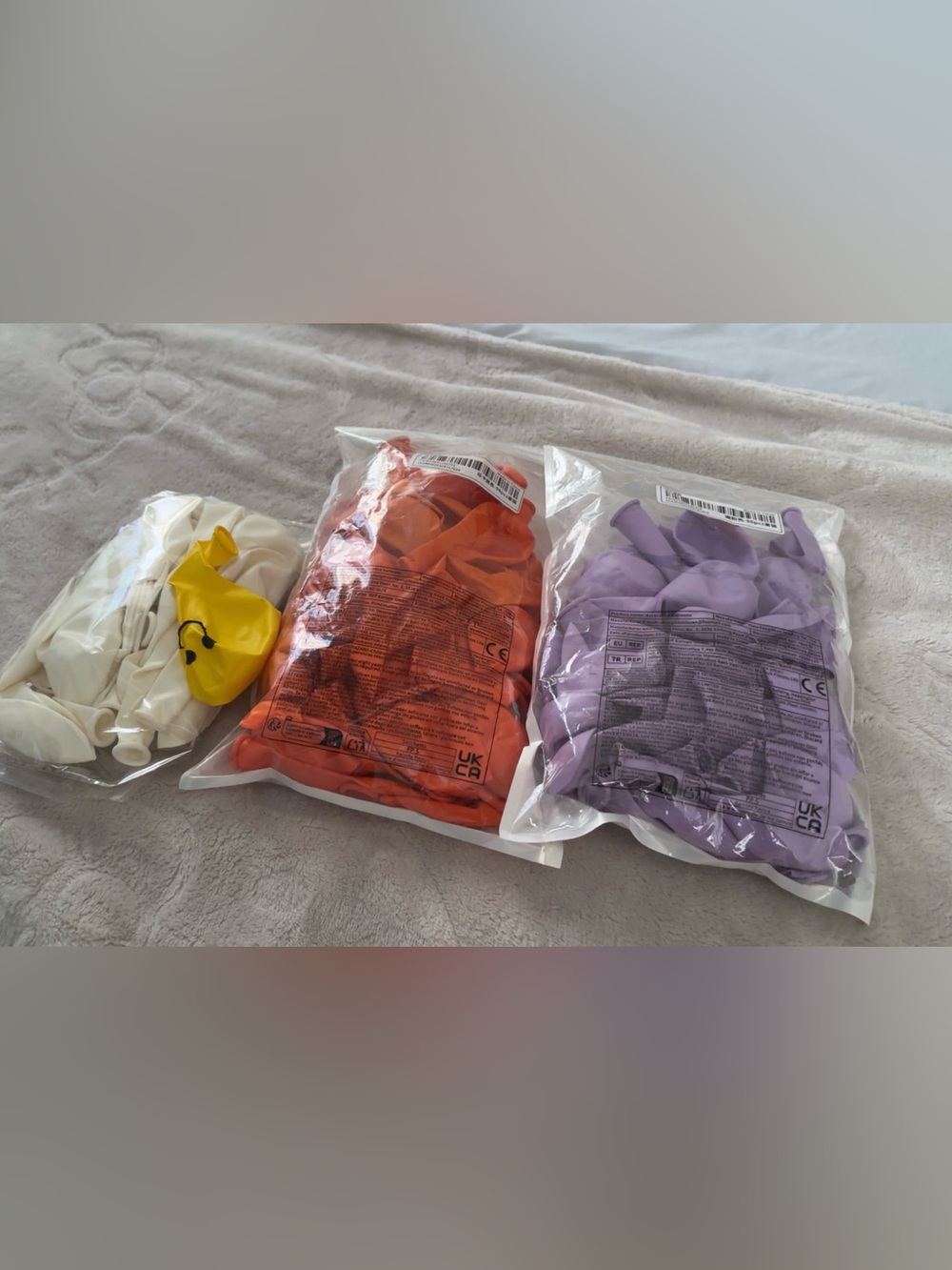 Balloons in orange, light purple, and white